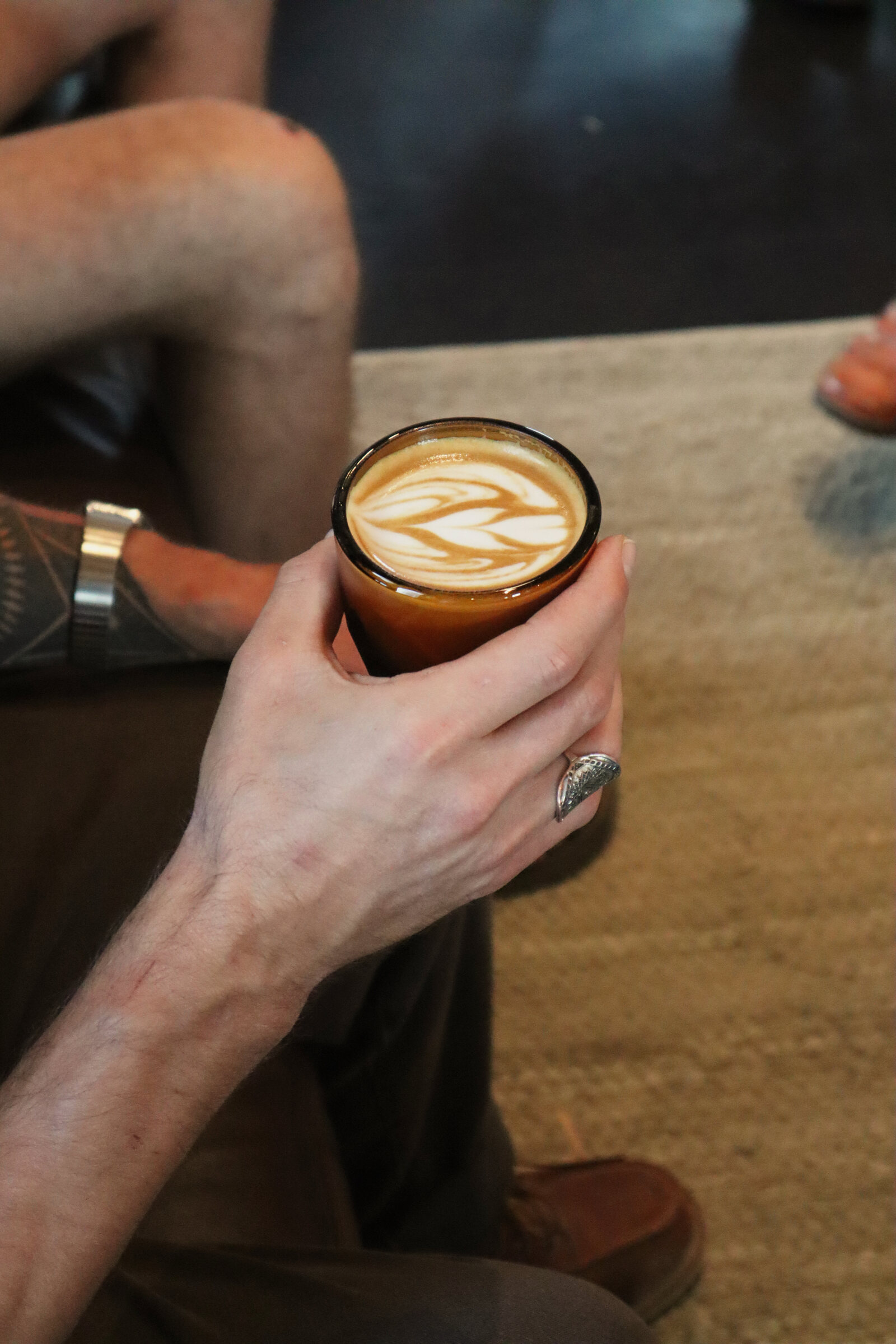 Hands holding a latte