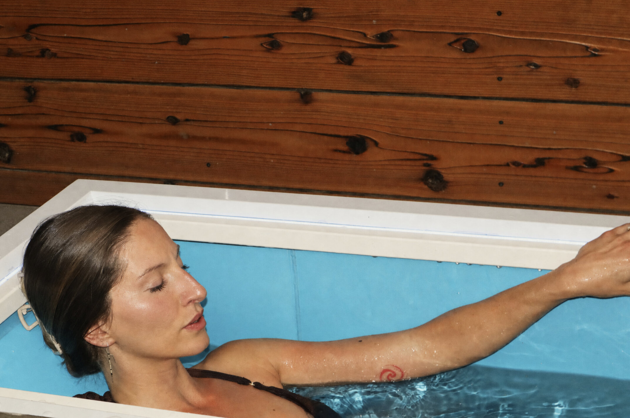 A woman floating in a cold plunge